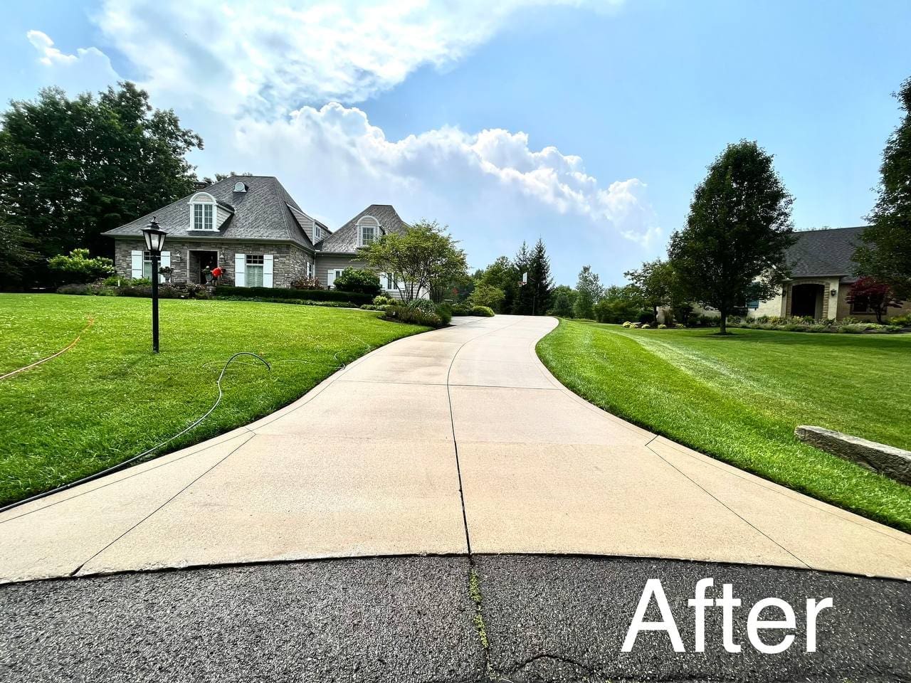 Residential driveway after professional power washing, Akron OH area