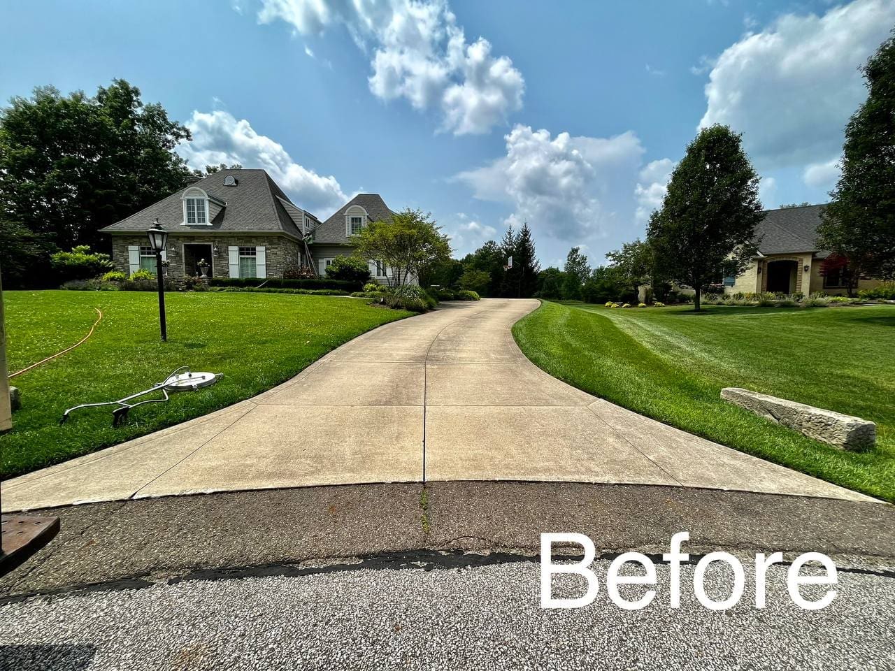 Residential driveway before professional power washing, Akron OH area