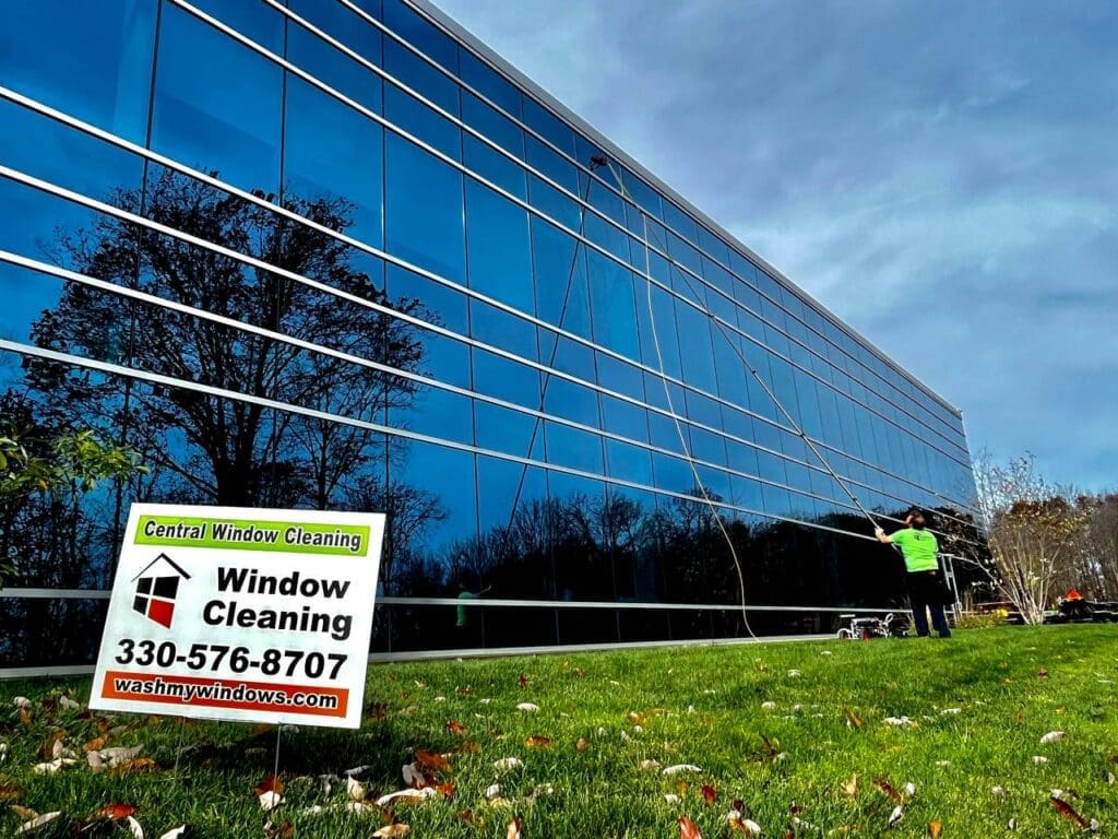 Central Window Cleaning technician cleaning exterior windows and trim on a residential home, Akron OH area
