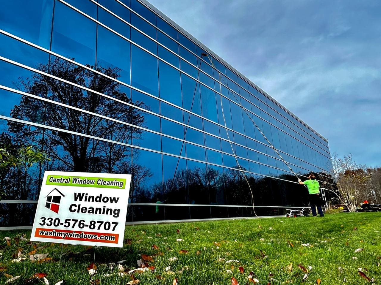 Central Window Cleaning technician cleaning exterior windows and trim on a residential home, Akron OH area