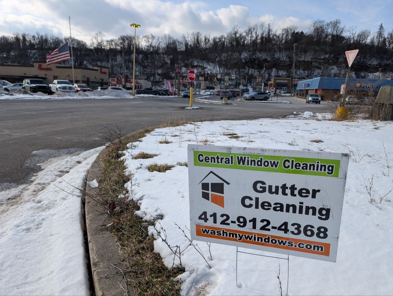 Central Window Cleaning gutter cleaning yard sign at a Pittsburgh PA area shopping center